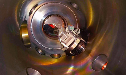 An electron multiplier inside a vacuum chamber