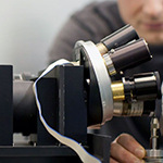 A researcher working with a piece of advanced laboratory equipment.