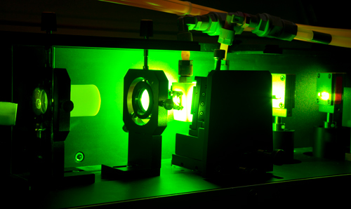 Machinery in dark room emitting green light