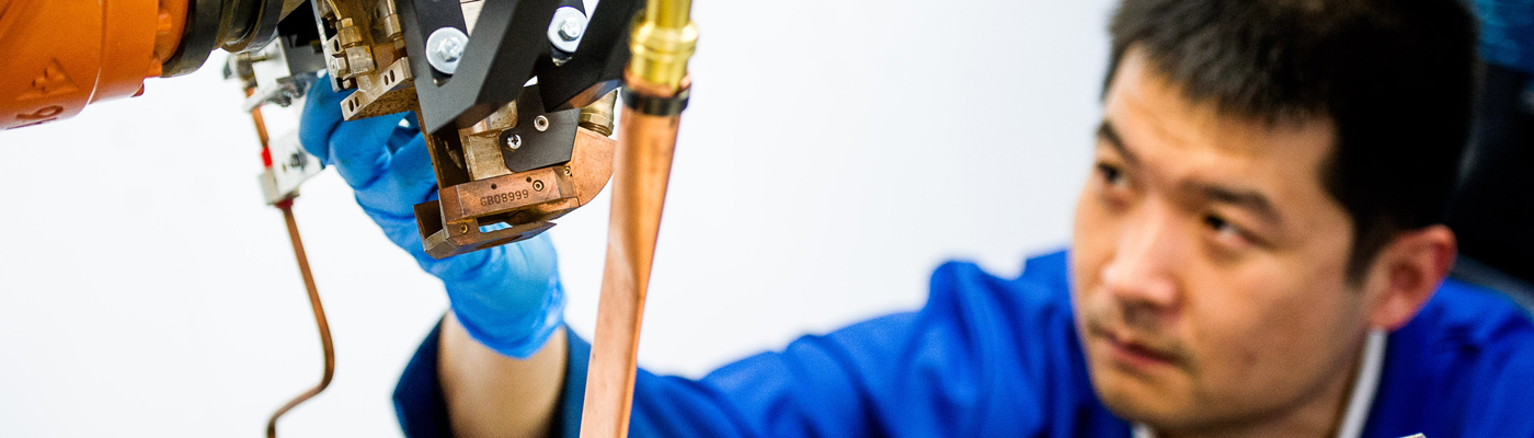 Blue coated researcher focusing on a surface